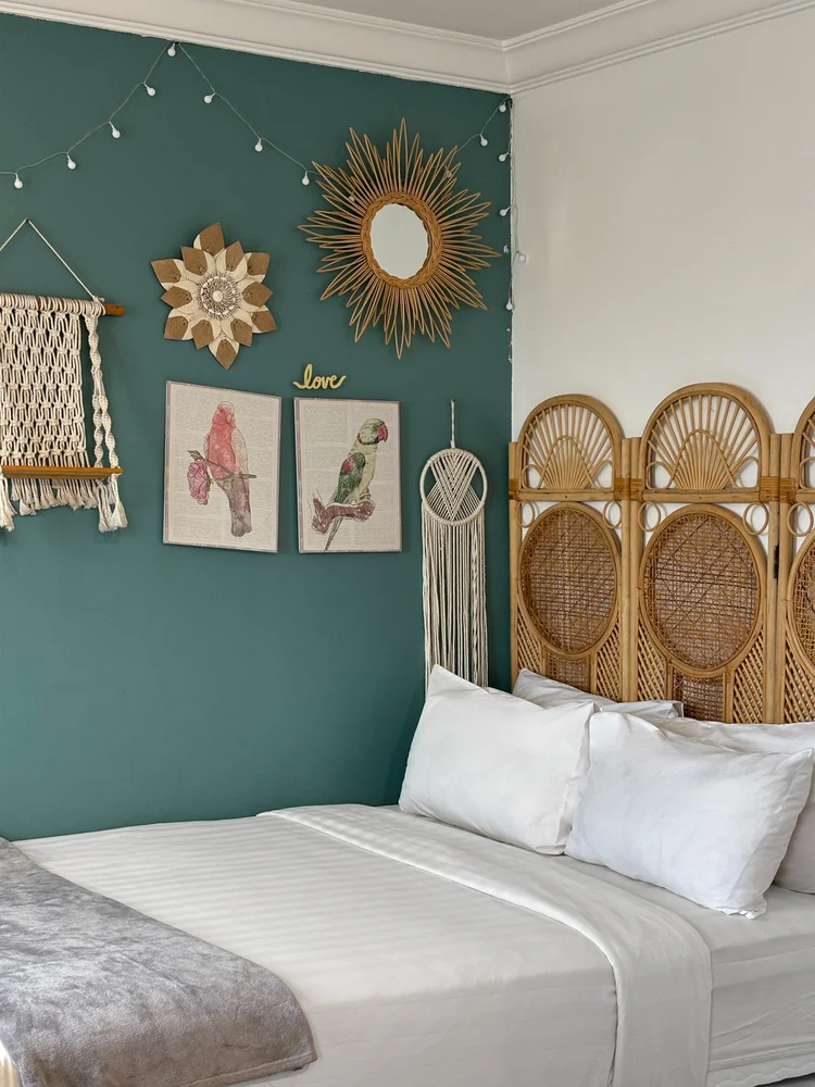 Florence: The second bedroom in teal, with rattan and macrame wall decor.