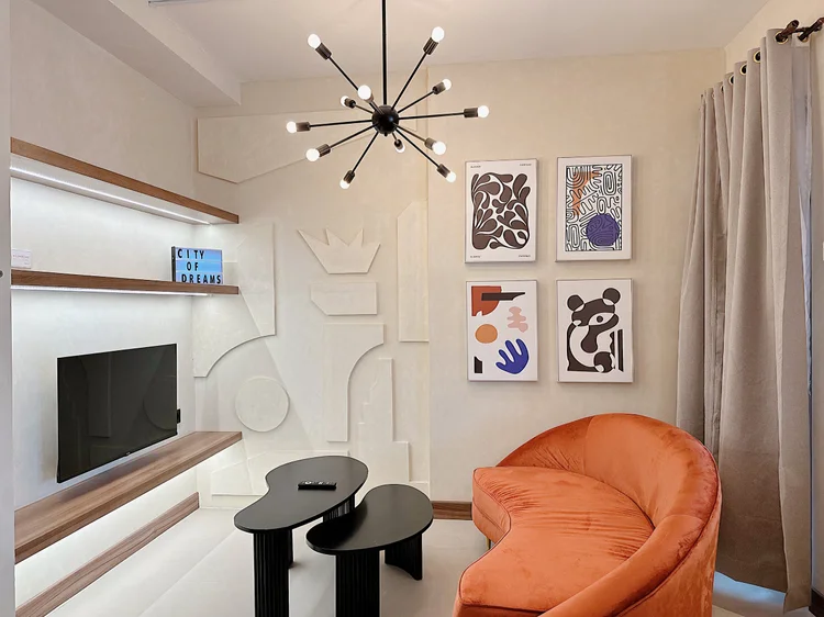 New York: A two-seater sofa facing the smart TV with Netflix, art prints on the wall.