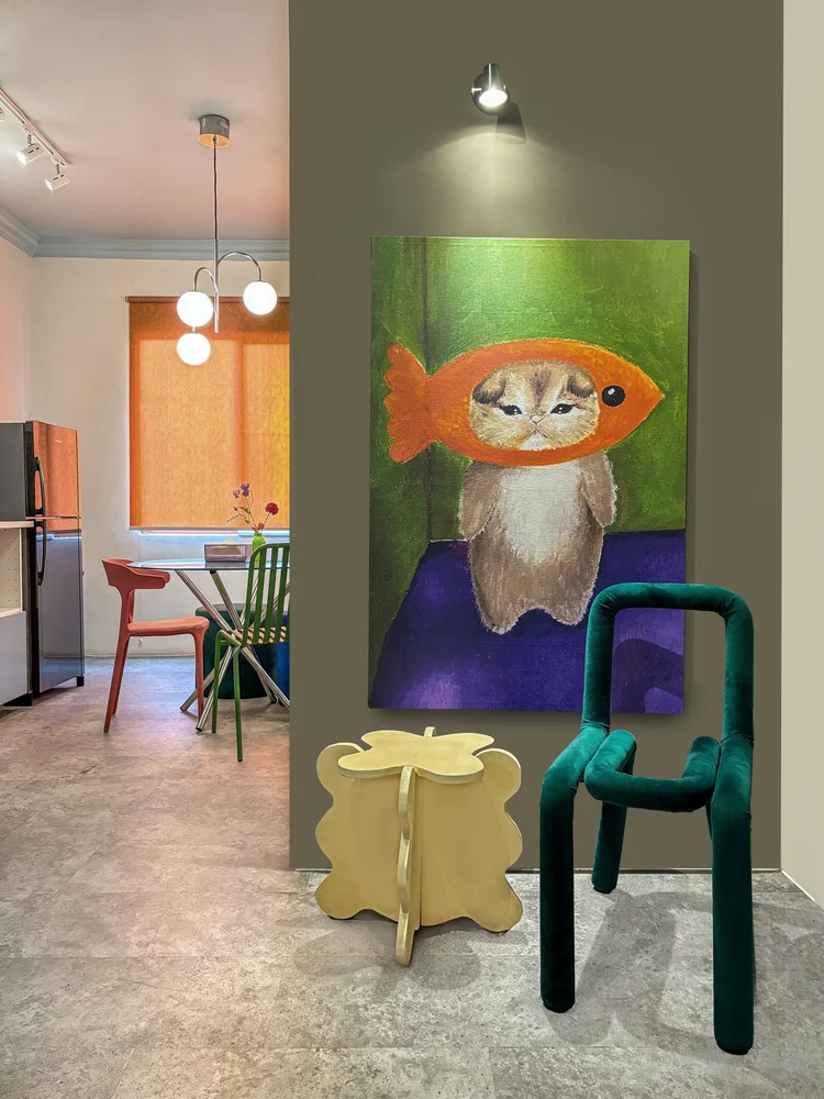 Vancouver: A green chair and a big painting in the corner, playful spaceage style.