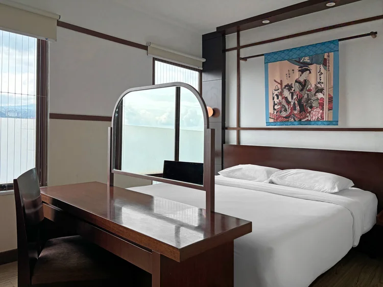 Okinawa: A dressing table and mirror in this bedroom, with a Japanese-style painting.