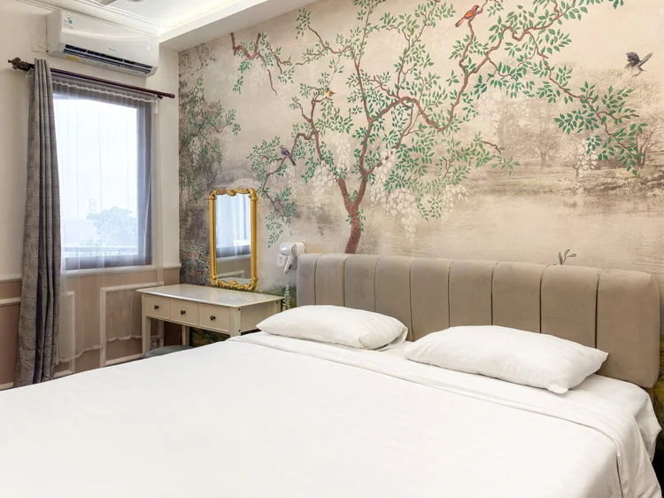 Salzburg: A bedroom with dressing table, gold-framed mirror and a curtained window.