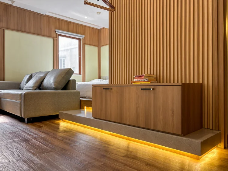 Sapporo: The sofa on its lit wood platform, a slatted screen to the bed area.