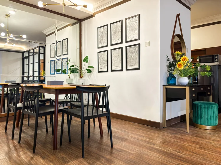 Norfolk: A dining table for six under a row of framed city maps.