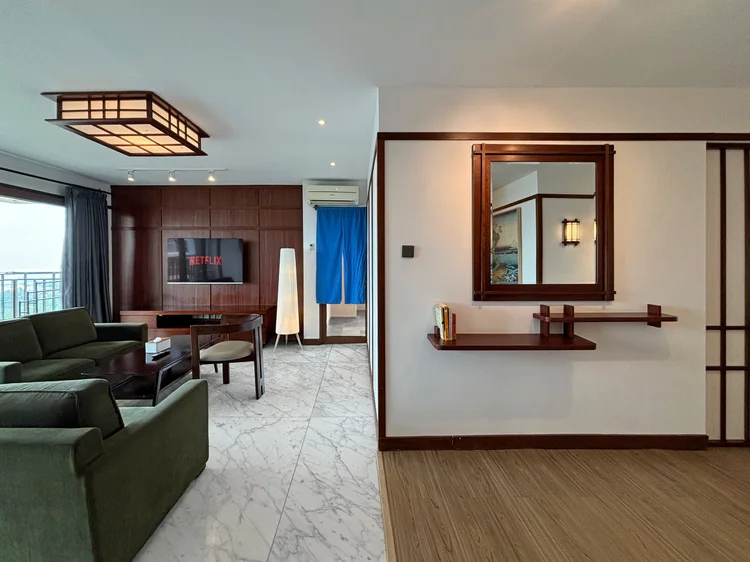 Okinawa: A round mirror and console table by the entrance, a last look before heading out.