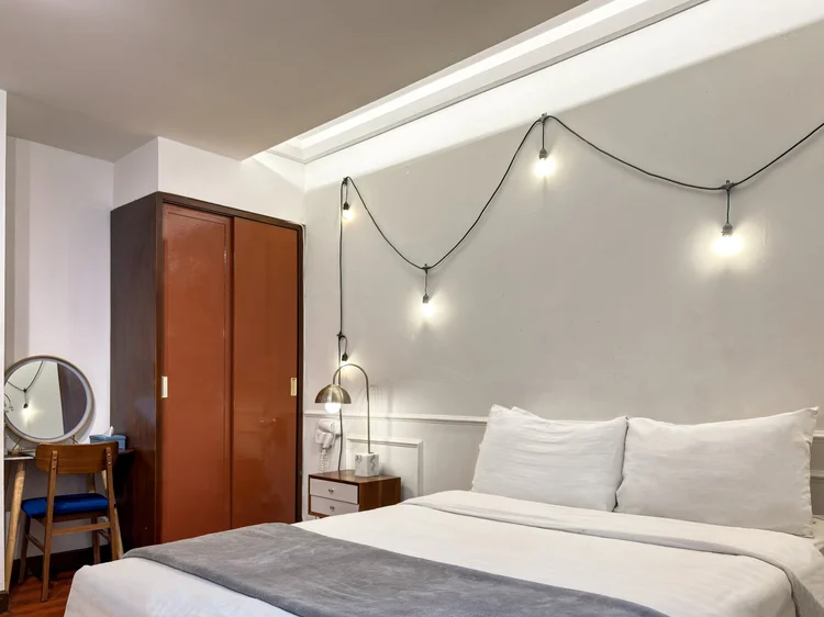 Provence: Wardrobe and dressing table beside the bed, with AC in the bed area.