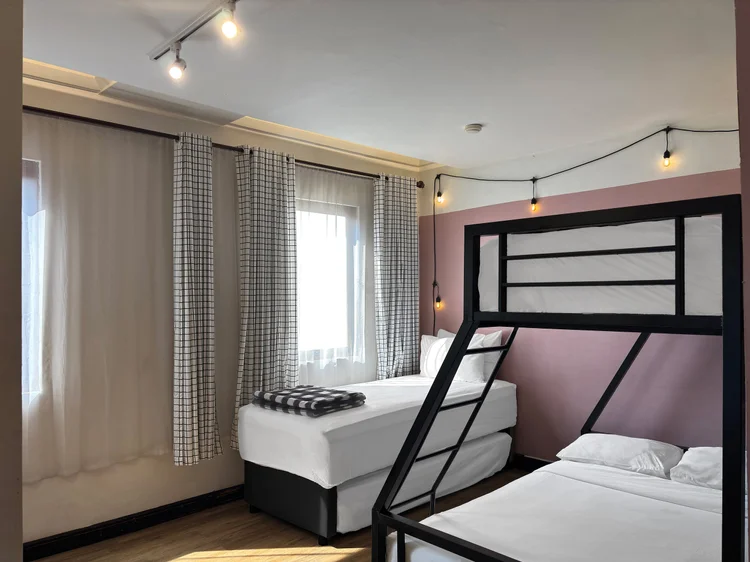Myeong-dong: Black-framed bunk beds with AC, the lower bed wider.