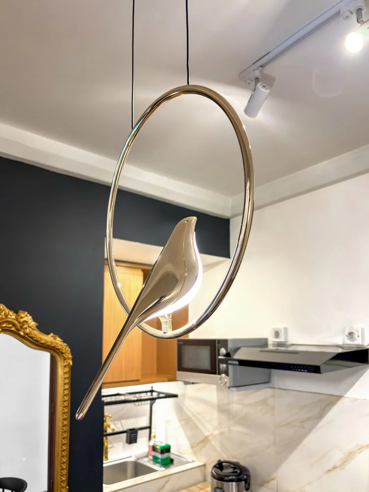 Vienna: A bird-shaped pendant lamp over the dining table, a distinctive Classical-theme detail.