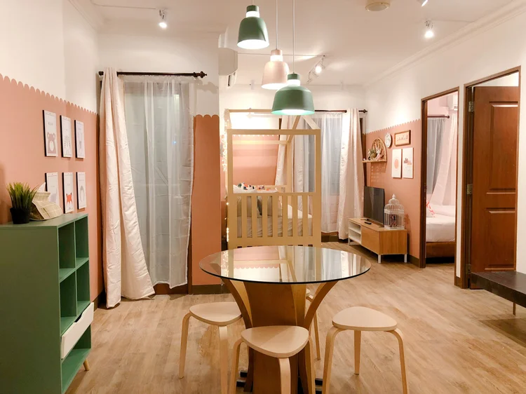 Madison: A round dining table for four, sharing the living room with the house bed.