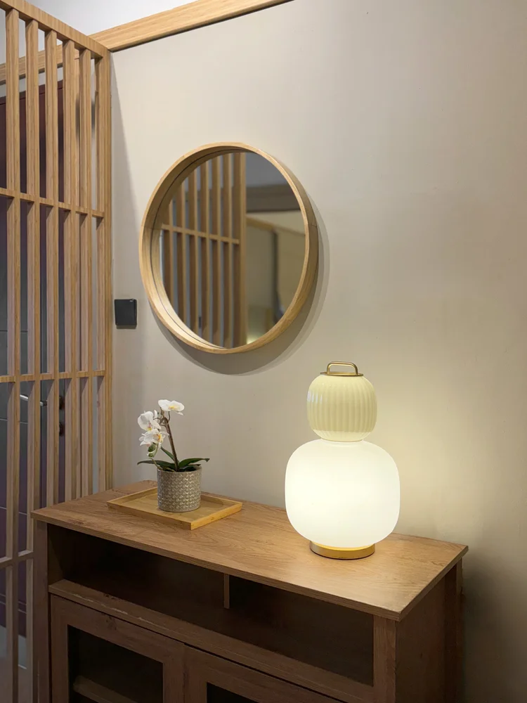 Fukuoka: Round mirror and table lamp on the entry console, a quiet Japanese touch.