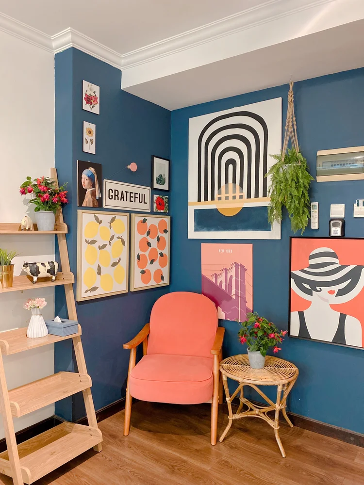 Palermo: Ladder shelf and a coral armchair under the gallery wall, a warm corner to sit.