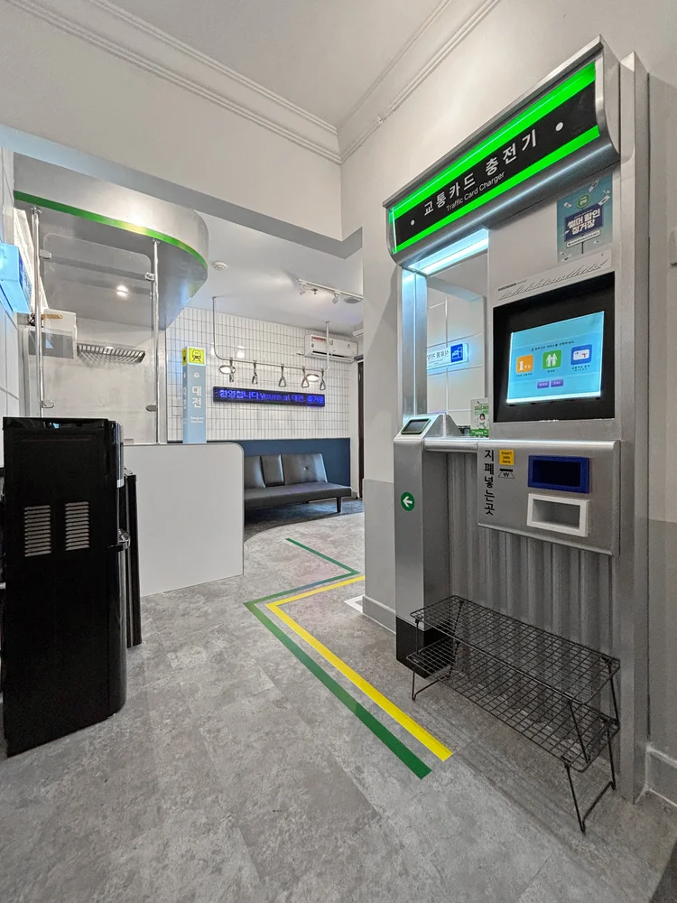 Dae Jeon: A decorative panel styled like a ticket machine, a small nod to the train station theme.