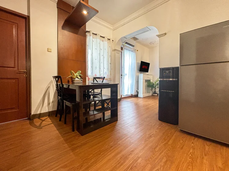 Marseille: The dining area with the door to a small balcony, the fridge close by.
