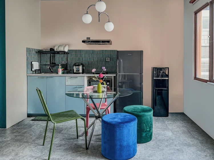 Vancouver: The blue open kitchen and dining table, a water dispenser with a spare gallon.