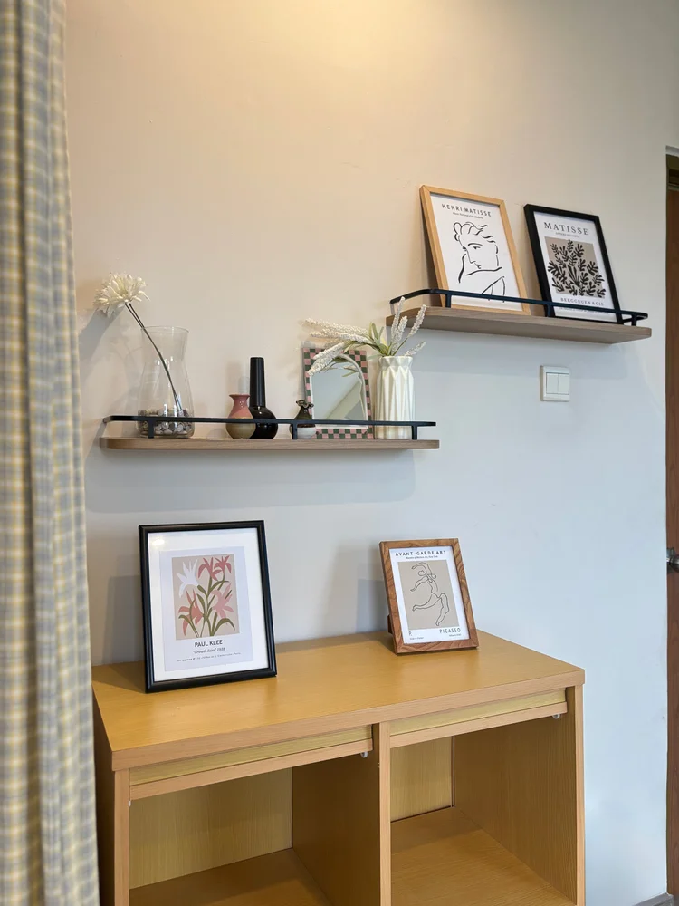 Seoul: Wall shelves with framed prints and a small wood table, set-dressed like a K-drama.