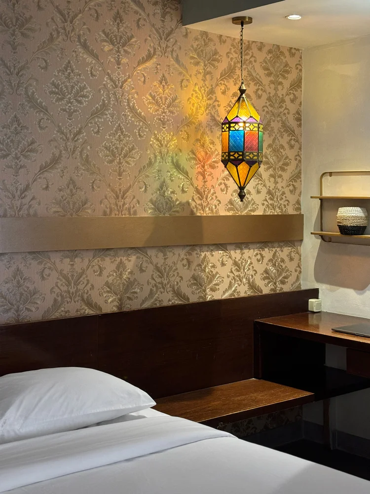 Marrakech: A Moroccan lantern over the bed, the dressing table alongside.