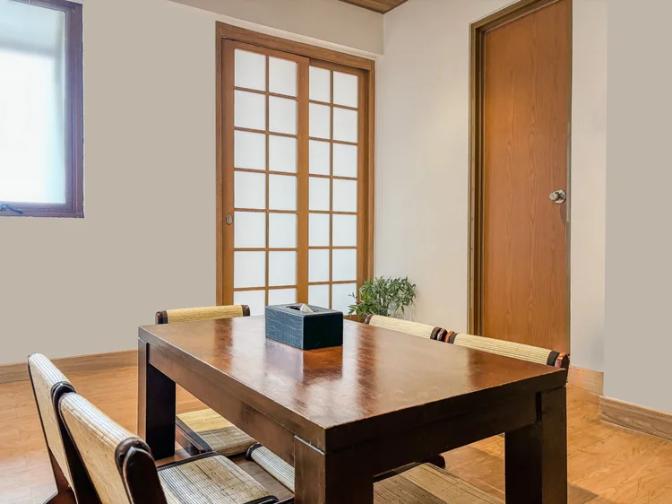 Yokohama: A corner of the dining area with a wood-framed shoji window and a door to the bedrooms.