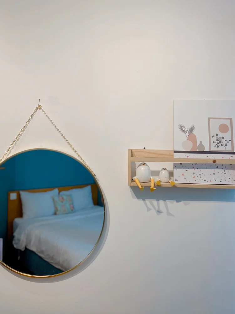 Madison: A round mirror and a little shelf, nursery details right down to the wall.