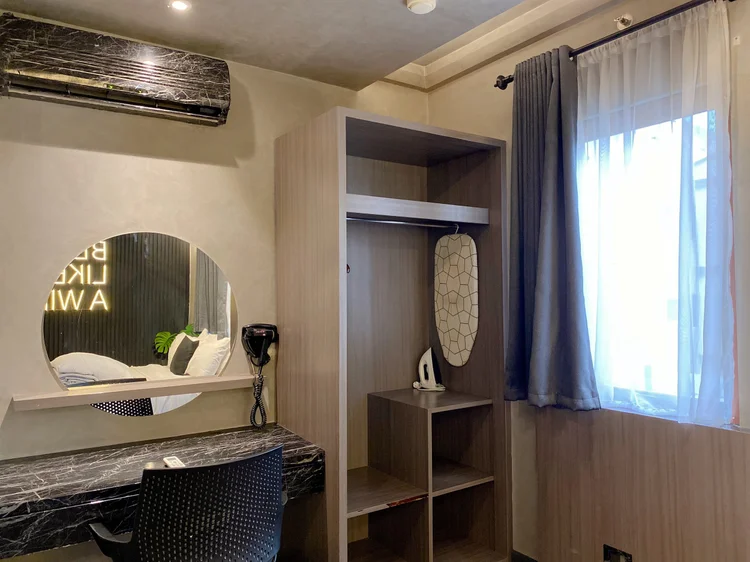 Kingston: Open wardrobe, round mirror, AC and an iron, ready for a longer stay.
