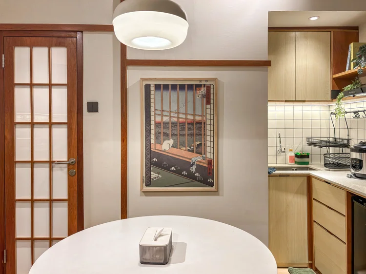 Kanazawa: A round table for four under the pendant lamp, shoji doors alongside.