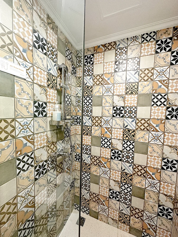 Malacca: A hot shower with patterned tiles, in the modern bathroom.