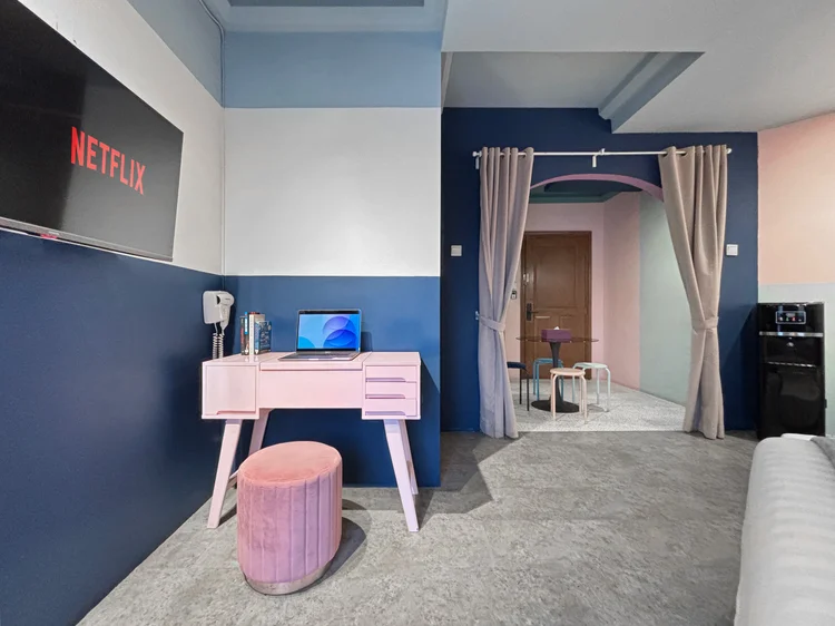 Montreal: The dressing table with a velvet stool, the dining table visible past the curtain.