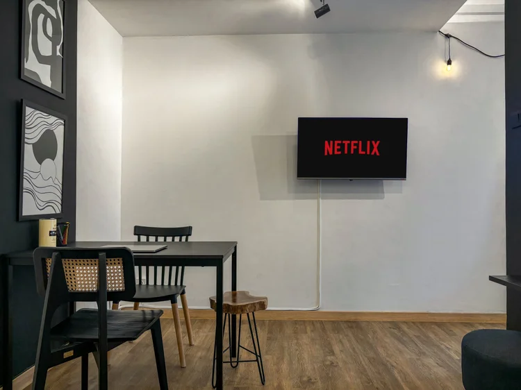Nairobi: A three-person dining table under the TV, dinner and a show.