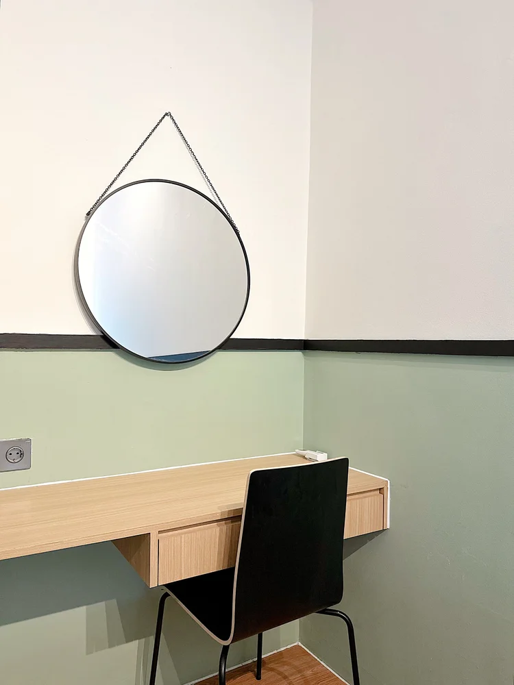 Berlin: Dressing table and mirror in the bedroom, with a chair to sit at.