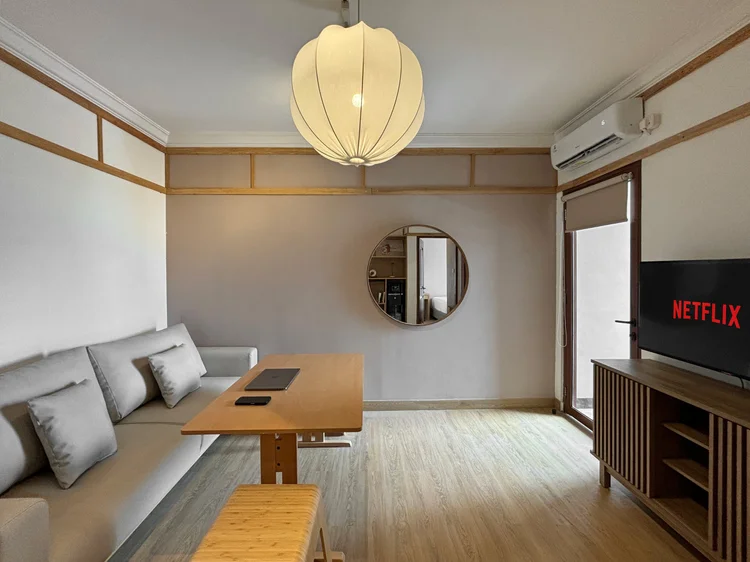 Hokkaido: The living room, with AC and the door to a small balcony.
