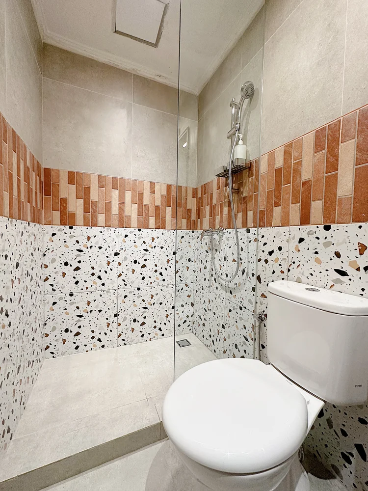Melbourne: A modern bathroom with a hot shower and terrazzo tiles.