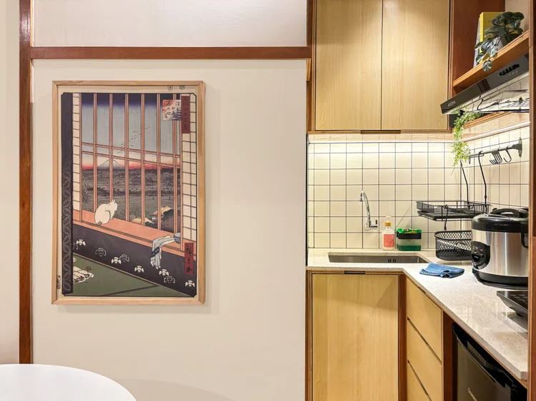 Kanazawa: Open kitchen with induction hob and rice cooker, a Japanese print on the wall.