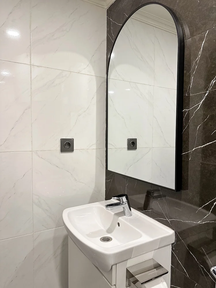 Boston: Washbasin with an arched mirror; soap and shampoo the same in every unit.