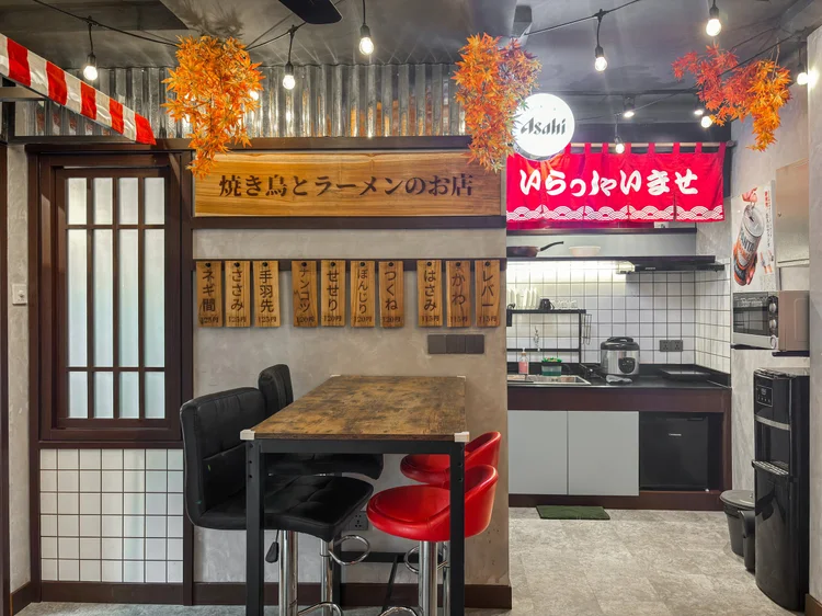 Shinjuku: Sleeps 5, up to 6 with extra beds; the modern open kitchen sits behind the bar table.