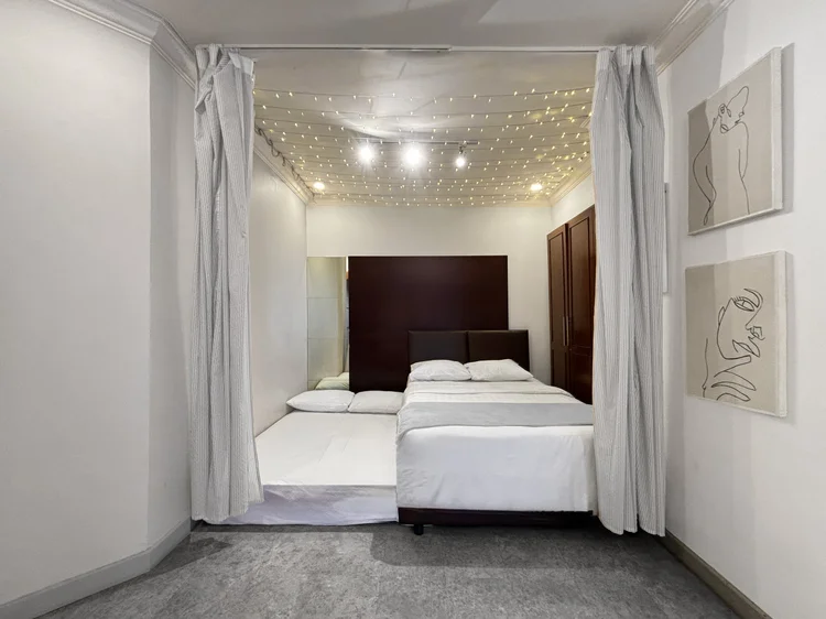 Ubud: A sliding bed: the lower half pulls out past the curtain, becoming a second bed in this room.