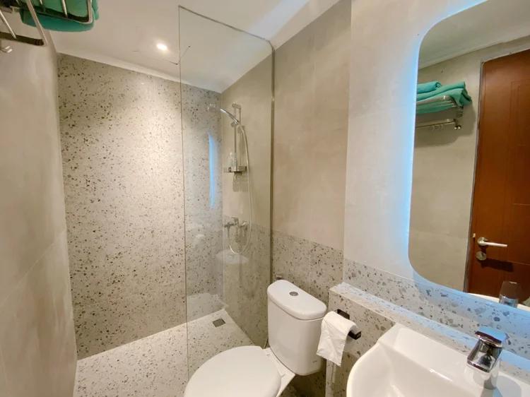 Budapest: Washbasin, mirror and a glass-screened shower; soap and shampoo the same in every unit.