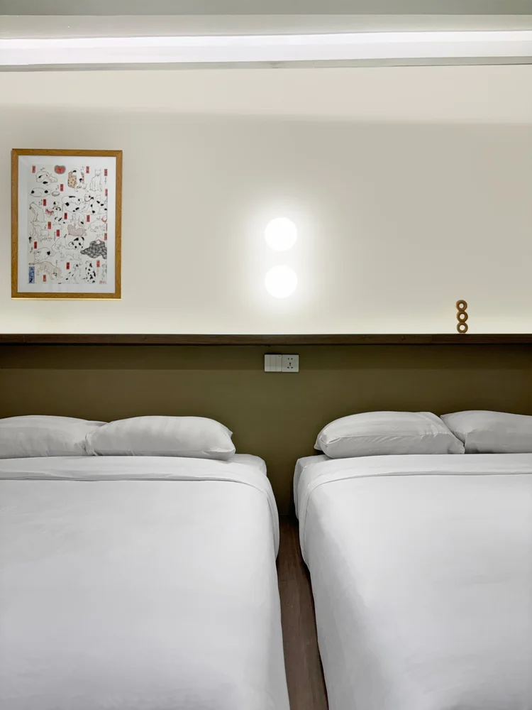 Aoyama: Two beds pushed together in the nook; sleeps 5, up to 6 with an extra bed.