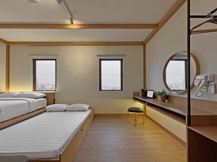 Nara: Master bedroom: the sliding bed pulled out into two beds side by side, with an ensuite bathroom.
