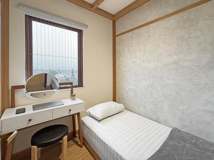 Nara: A bedroom with a 100 cm single bed, dressing table and its own AC.