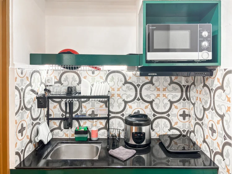 Tanzania: Open kitchen with a sink, microwave and rice cooker; the basic cooking tools are all there.