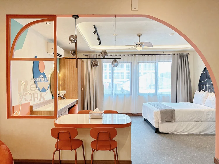New York: The orange arch frames the dining table and the sleeping area.