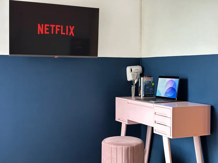 Montreal: Smart TV with Netflix above the dressing table, a hair dryer on the wall.