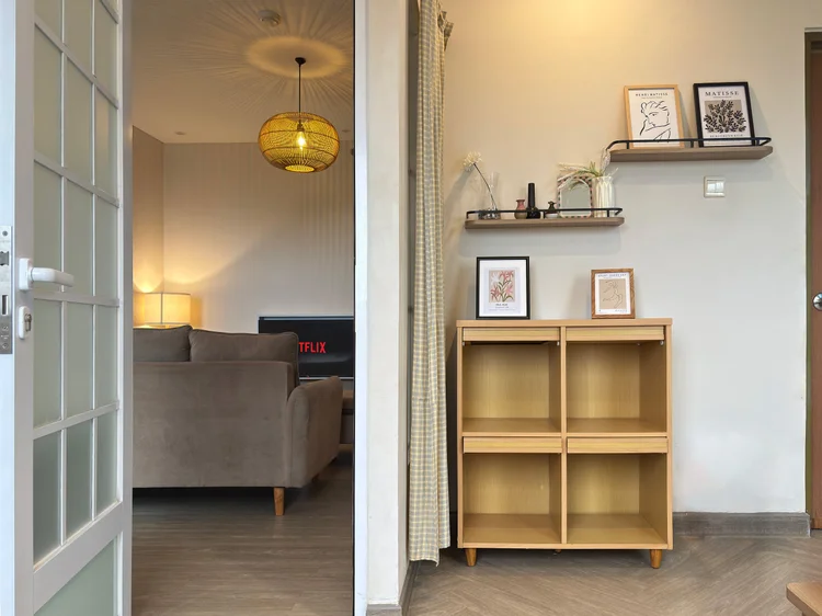 Seoul: A glass door from the bedroom to the living room, open wood shelving for your things.