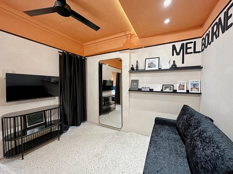 Melbourne: The living room: a black velvet sofa, smart TV and ceiling fan.