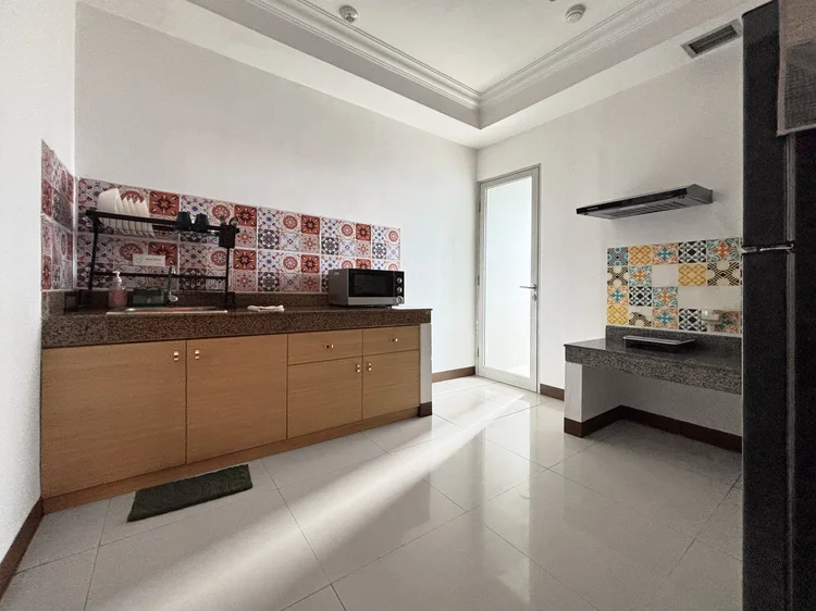 Namibia: Enclosed kitchen with a microwave and dish rack, cooking smells kept out of the living room.