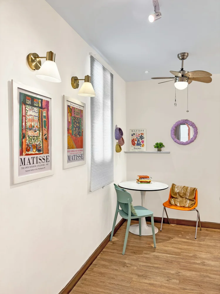 Milan: The dining corner with Matisse prints and a round purple mirror.
