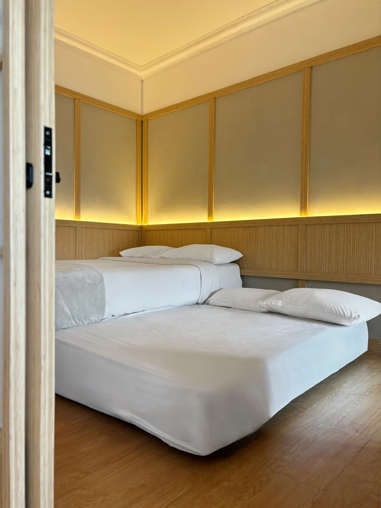 Fukuoka: The bedroom, with AC and wall lamps, wrapped in shoji panels.