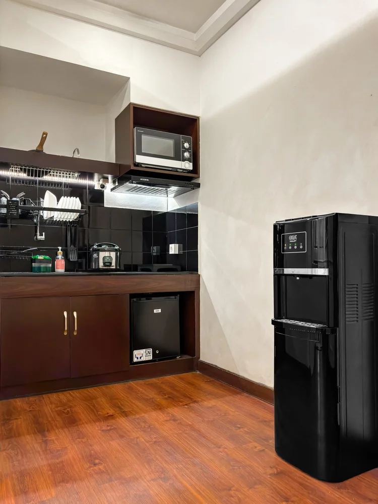 Provence: Open kitchen with fridge and water dispenser, plus a spare water gallon in every unit.