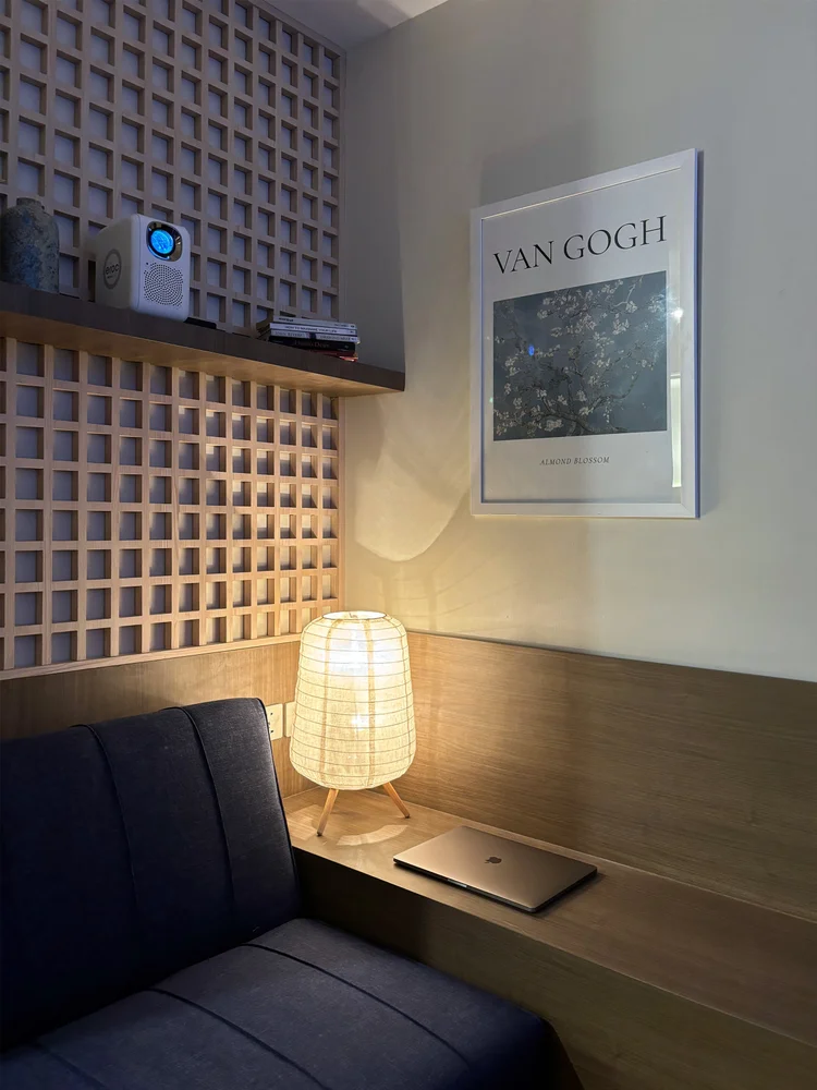 Aoyama: A reading corner with a lamp and poster, next to the sofa.