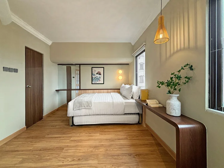 Nakameguro: The bedroom with a woven pendant lamp and a long shelf by the window.
