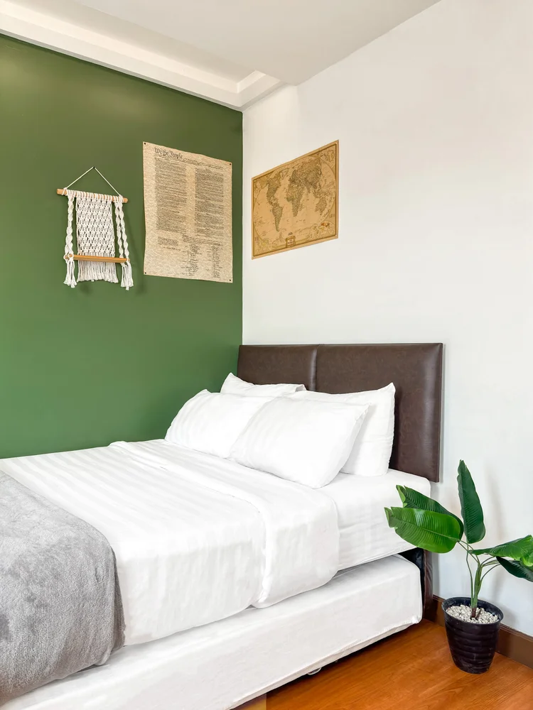 Tanzania: A sliding bed: the lower half pulls out as a second bed; white sheets the same standard in all our units.