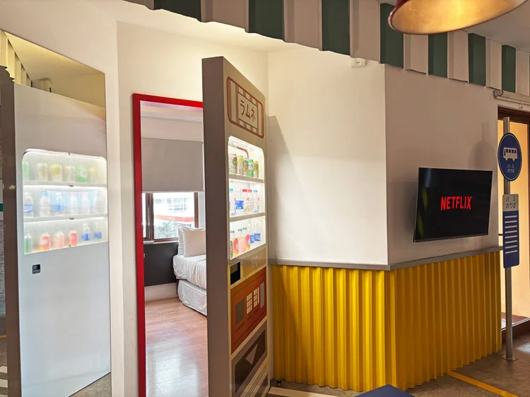 Shibuya: From the sleeping area: the smart TV and a living room styled like a Tokyo street.